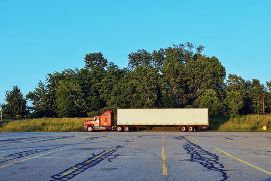 Red and white freight truck on the highway — bonded carriers move in-bond freight through Canada