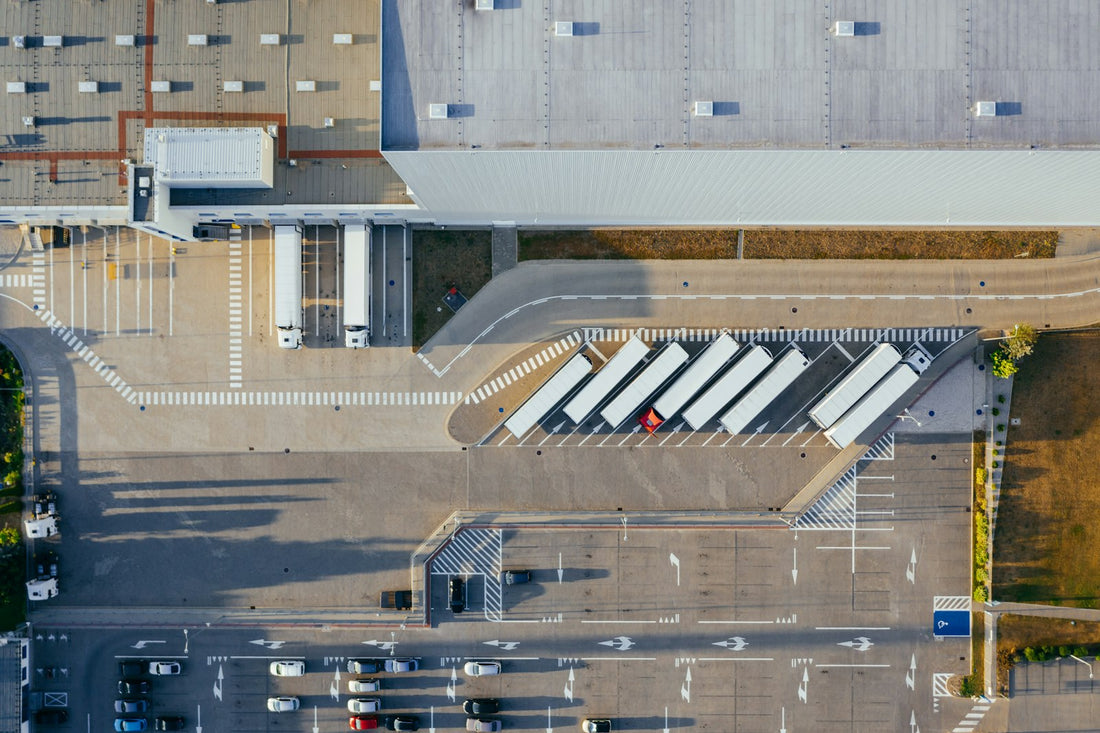 aerial view of vehicles in parking area — cross-border freight (Unsplash, Marcin Jozwiak)