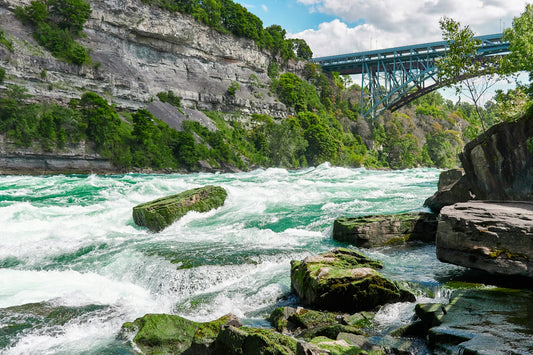 Rainbow bridge seen from Niagara White Water Walk. — cross-border freight (Unsplash, Satyakam Khadilkar)
