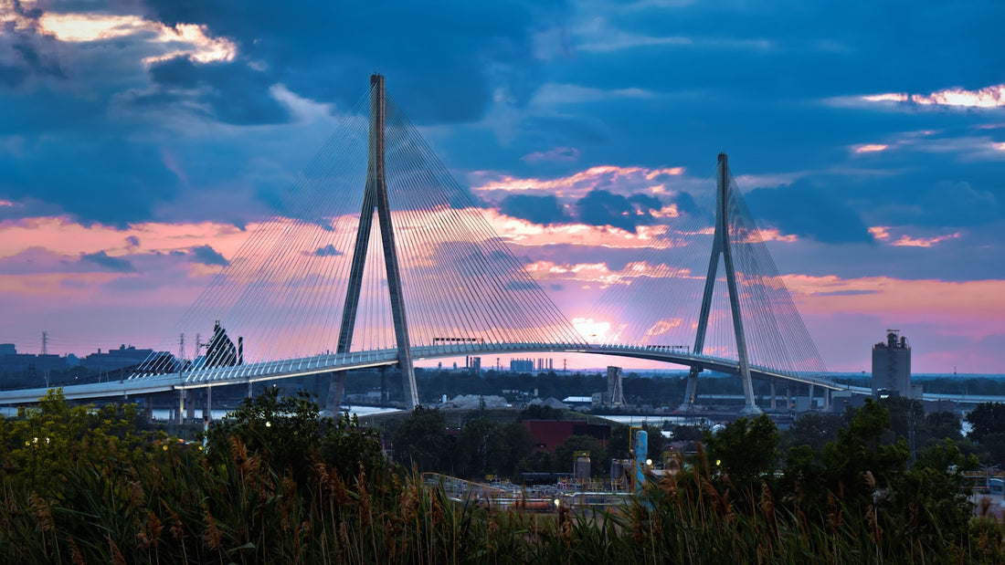 Modern cable-stayed bridge at sunset with vibrant sky